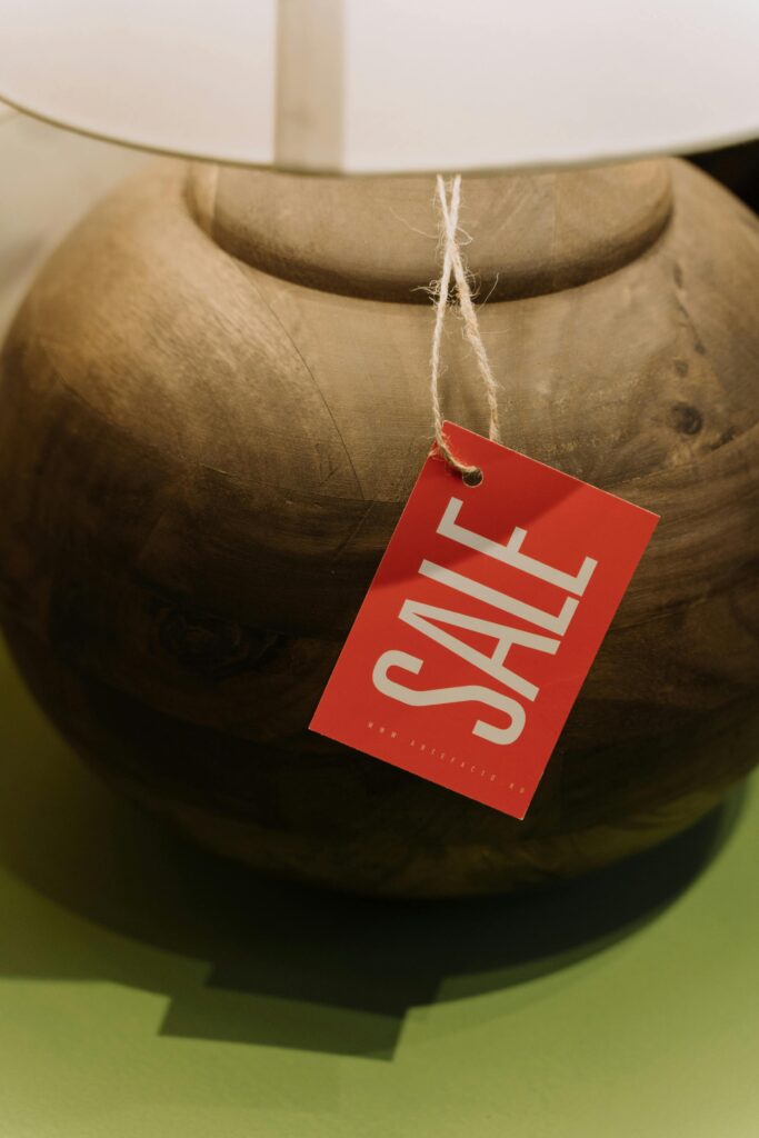 Photo of a wooden lamp with a 'For Sale' tag attached. The lamp is displayed in a well-lit setting, showcasing its craftsmanship and design. The image highlights the lamp’s availability for purchase, emphasizing its unique character and potential as a decorative item.