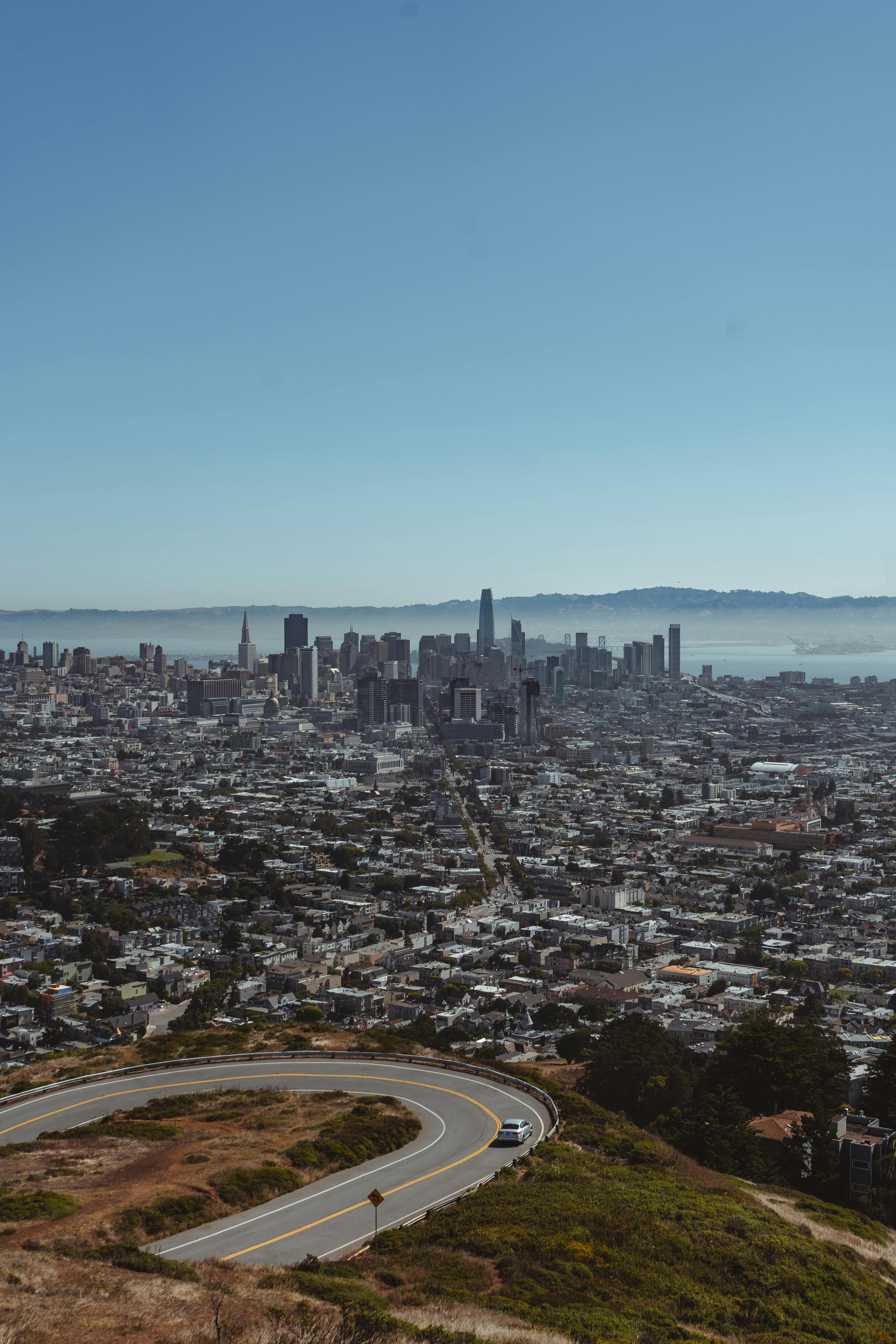 Photo of a city landscape, featuring a panoramic view of urban buildings, streets, and green spaces. The cityscape includes a mix of modern skyscrapers and historic architecture, with bustling streets and vibrant activity, capturing the dynamic and diverse nature of the urban environment.