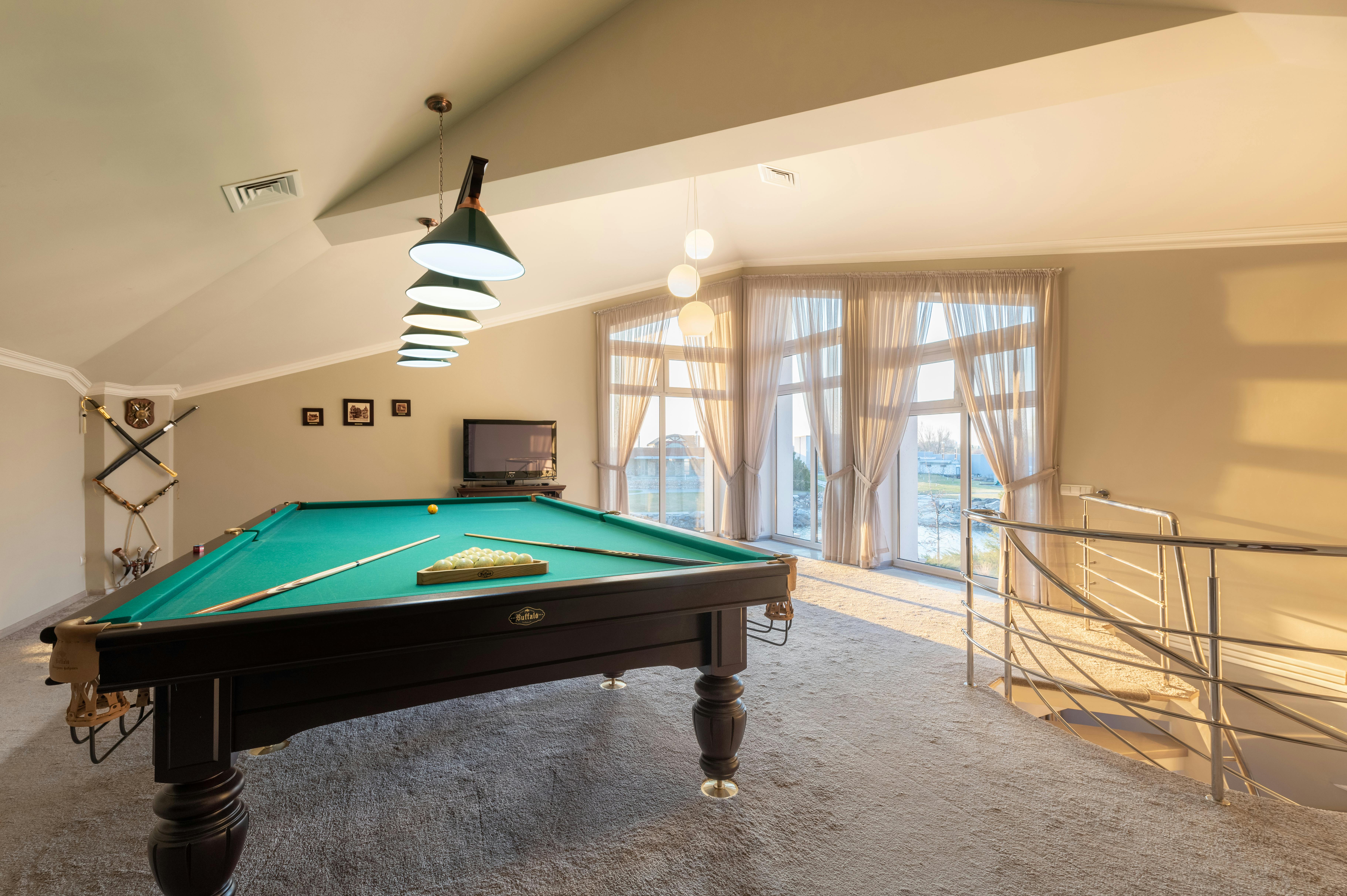 Photo of a pool table in a well-lit room, featuring its sleek design and vibrant green felt. The image emphasizes the pool table’s pristine condition and the careful handling it requires, showcasing the moving company's expertise in relocating and setting up such large and intricate items.